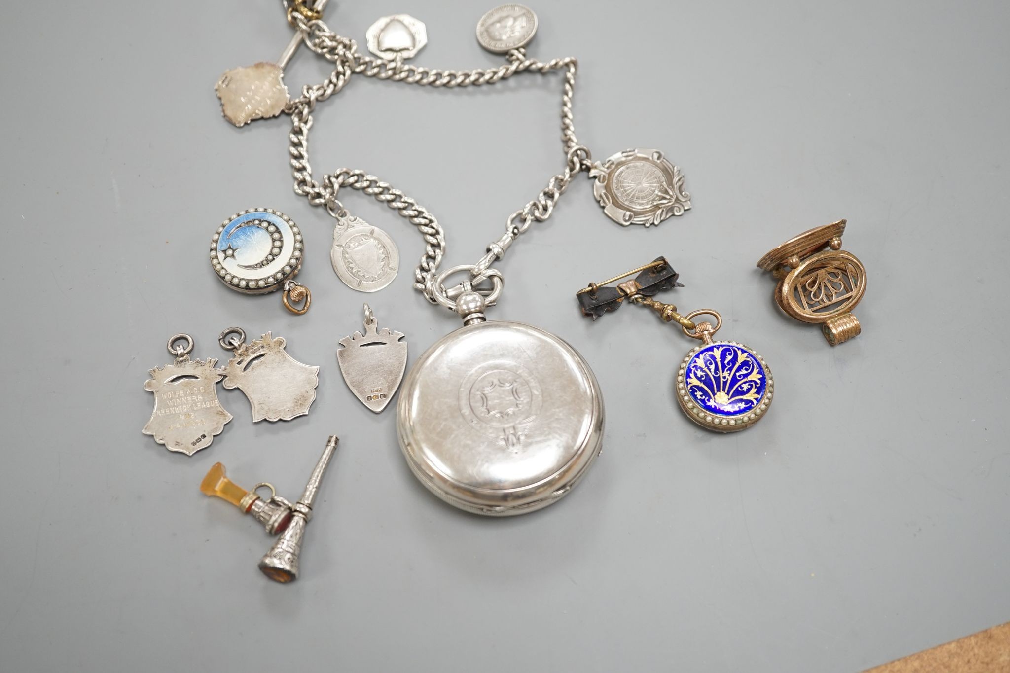 A George V silver open faced lever pocket watch, by A. Yewdall, Leeds, on a silver albert hung with silver medallions, two Swiss white metal and enamel fob watches, gilt fob seal, etc.